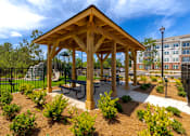 Thumbnail 8 of 23 - Community pavilion with landscaped green space at Springview Apartments located near Panthersville in Decatur, Georgia.