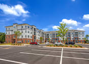 Thumbnail 23 of 23 - Exterior view of Springview Apartments featuring modern apartment homes and convenient parking near Panthersville Road in Decatur, Georgia.