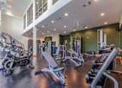Thumbnail 12 of 28 - 1-Bedroom Apartments in Old East Dallas, TX - 4600 Ross - Multi-Level Fitness Center with Mirror Wall, Free Weights, Cable Machines, Workout Benches, Cardio Equipment, Rock Climbing Wall, and Ceiling Fans.