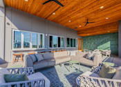 Thumbnail 22 of 28 - a living room filled with furniture and a wooden ceiling