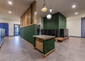 Thumbnail 26 of 28 - a large room with a table and benches in front of a green wall