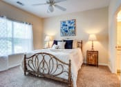 Thumbnail 8 of 27 - Villas at Hannover Apartments in Stockbridge, GA photo of bedroom with large window and ceiling fan