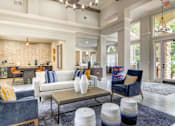 Thumbnail 16 of 19 - A living room with a white couch and a blue chair.