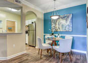 Thumbnail 6 of 19 - A kitchen with a table and chairs.