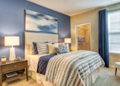 Thumbnail 10 of 19 - A bedroom with a large bed and a painting on the wall.