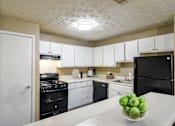 Thumbnail 1 of 29 - Kitchen with black appliances and gas range in Marietta apartment home