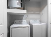 Thumbnail 12 of 20 - Sugar Mill Apartments in Addis, LA photo of a white laundry room with two washes and a dryer