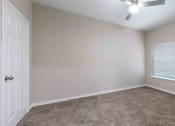 Thumbnail 11 of 20 - Sugar Mill Apartments in Addis, LA photo of an empty bedroom with a white door and a window