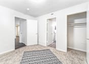 Thumbnail 11 of 21 - Unfurnished bedroom with en suite bathroom and closet at Sugar Creek Apartments Winston Salem NC