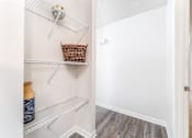 Thumbnail 13 of 21 - Apartment storage shelving area at Sugar Creek Apartments in Winston Salem NC with built in shelves and wood style flooring