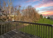 Thumbnail 8 of 14 - Pet-Friendly Townhomes in Burnsville, MN – Summit Townhomes - the view from the balcony of a home with a sunset