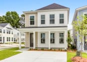Thumbnail 24 of 25 - Townhouses for Rent in Park Circle SC - Sumner Village - Exterior View of Townhome with Private Driveway and Lush Landscaping