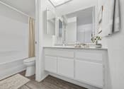 Thumbnail 15 of 21 - Bathroom with sink vanity at Sunnyside Senior Apartments San Dimas CA