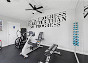 Thumbnail 3 of 21 - Fitness center with equipment for light exercise at Sunnyside Senior Apartments in San Dimas, California