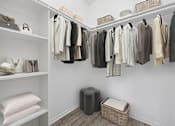 Thumbnail 14 of 21 - Walk-in closet with built-in shelving at Sunnyside Senior Apartments San Dimas