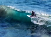 Thumbnail 29 of 29 - a surfer riding a wave in the ocean
