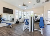 Thumbnail 30 of 55 - A spacious home gym with a variety of exercise equipment.