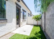 Thumbnail 23 of 55 - A modern house with a white exterior and a small garden area.