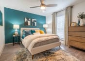 Thumbnail 6 of 20 - The Jaunt Apartments in Charleston South Carolina photo of a bedroom with a bed and a ceiling fan