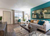 Thumbnail 1 of 20 - The Jaunt Apartments in Charleston South Carolina photo of living room with hardwood flooring a couch and tv stand