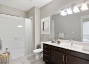 Thumbnail 9 of 29 - bathroom with dark wood vanity and tub shower