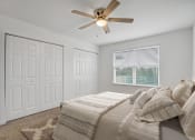 Thumbnail 8 of 19 - The Marley at Trout River Apartments in Jacksonville, FL 32218 a bedroom with a bed and a ceiling fan