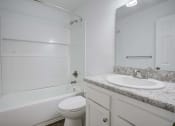 Thumbnail 7 of 19 - The Marley at Trout River Apartments in Jacksonville, FL 32218 photo of a bathroom with a sink toilet and a shower