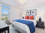 Thumbnail 17 of 50 - Apartments In Greenwood, WA For Rent - The Morrow - Spacious Bedroom With Plush Carpet Flooring, Floor-to-Ceiling Window, And Ceiling Light
