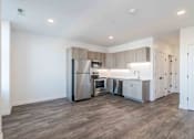 Thumbnail 13 of 27 - a kitchen with stainless steel appliances and wooden floors