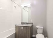 Thumbnail 25 of 27 - a bathroom with a toilet sink and mirror