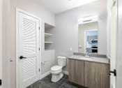 Thumbnail 21 of 27 - a bathroom with a toilet sink and a mirror