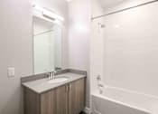 Thumbnail 22 of 27 - a bathroom with a sink and a tub and a mirror