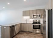 Thumbnail 2 of 27 - a kitchen with stainless steel appliances and wooden cabinets