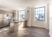 Thumbnail 14 of 27 - an empty kitchen with stainless steel appliances and a large window