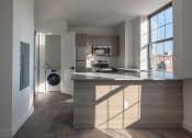 Thumbnail 15 of 27 - a kitchen with a large island and a washing machine