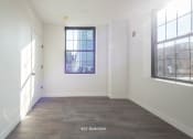Thumbnail 17 of 27 - an empty room with white walls and a window