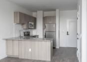 Thumbnail 10 of 27 - a kitchen with an island and stainless steel refrigerator