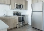 Thumbnail 3 of 27 - a kitchen with stainless steel appliances and wooden cabinets