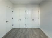Thumbnail 20 of 27 - a row of white closets in a room with wood floors