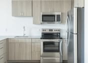 Thumbnail 1 of 27 - a kitchen with stainless steel appliances and white cabinets