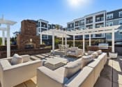 Thumbnail 11 of 29 - Sage at 1240 apartments in Mount Pleasant South Carolina photo of sundeck with outdoor seating, fireplace and grills