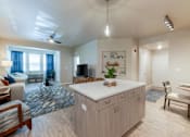 Thumbnail 4 of 32 - Contemporary kitchen with large island, stainless steel appliances, and pendant lighting at The Sanctuary at 331 in Santa Rosa Beach, FL
