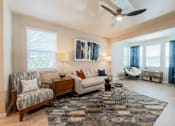 Thumbnail 5 of 32 - Bright and spacious living room with ceiling fan, stylish vinyl plank flooring, and open-concept layout at The Sanctuary at 331 in Santa Rosa Beach, FL
