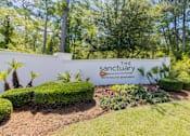 Thumbnail 32 of 32 - The Sanctuary sign is displayed on a wall with a garden in front.