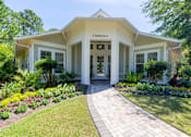 Thumbnail 28 of 32 - A white building with a sign that says Clubhouse.