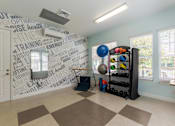 Thumbnail 3 of 32 - Bright fitness center with cardio machines and strength-training equipment at The Sanctuary at 331 in Santa Rosa Beach, FL