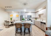 Thumbnail 1 of 32 - Modern apartment kitchen with stainless steel appliances, quartz countertops, and spacious island at The Sanctuary at 331 in Santa Rosa Beach, FL