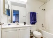 Thumbnail 7 of 11 - a bathroom with a sink toilet and tub and a mirror