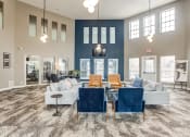 Thumbnail 8 of 11 - Apartments near Glendale Heights - large clubroom resident lounge with blue chairs and a couch and a table