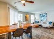 Thumbnail 5 of 11 - Apartments in Glendale Heights for rent - The Mark - living room with a dining room table and a couch